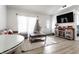 Open living space with a large TV, stylish décor, and lots of natural light at 3144 Voigt Dr, Indianapolis, IN 46224