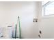Bare room featuring a window, utilities connections, and a clean, freshly painted wall at 3144 Voigt Dr, Indianapolis, IN 46224