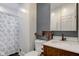 Updated bathroom with gray accent wall, wood vanity, and shower at 317 N Arsenal Ave, Indianapolis, IN 46201