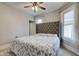 Bright bedroom featuring a comfortable bed and ceiling fan at 317 N Arsenal Ave, Indianapolis, IN 46201