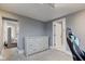 Gray bedroom with a dresser and access to bathroom at 317 N Arsenal Ave, Indianapolis, IN 46201