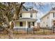 Two-story house with a front porch and a black metal fence at 317 N Arsenal Ave, Indianapolis, IN 46201