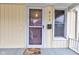 Front door with a welcome mat and storm door at 317 N Arsenal Ave, Indianapolis, IN 46201