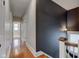 Long hallway with hardwood floors and a dark accent wall at 317 N Arsenal Ave, Indianapolis, IN 46201