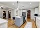 Open concept kitchen features a large island and hardwood floors at 317 N Arsenal Ave, Indianapolis, IN 46201