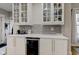 White kitchen cabinets with glass-front upper cabinets and wine cooler at 317 N Arsenal Ave, Indianapolis, IN 46201