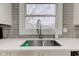 Modern kitchen sink with gray brick backsplash and a pull-down faucet at 317 N Arsenal Ave, Indianapolis, IN 46201