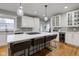 Updated kitchen with island seating, white cabinets, and hardwood floors at 317 N Arsenal Ave, Indianapolis, IN 46201