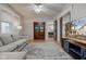 Spacious living room with hardwood floors, large TV, and built-in shelving at 317 N Arsenal Ave, Indianapolis, IN 46201