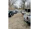 Unkempt backyard featuring multiple vehicles and discarded items in disarray at 3306 N Drexel Ave, Indianapolis, IN 46218