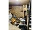 Unfinished basement with plywood walls filled with boxes and car parts at 3306 N Drexel Ave, Indianapolis, IN 46218