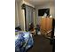 Small bedroom cluttered with furniture, a chair, and personal items at 3306 N Drexel Ave, Indianapolis, IN 46218