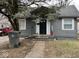 Charming one-story home with a gray exterior, mature trees, and a welcoming front porch at 3306 N Drexel Ave, Indianapolis, IN 46218