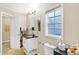 A well-lit bathroom complete with a stylish vanity, toilet, and a linen closet for optimal storage at 3933 Byram Ave, Indianapolis, IN 46208