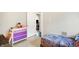 A bedroom featuring a colorful chest of drawers and a cozy bed, creating a fun and inviting space at 3933 Byram Ave, Indianapolis, IN 46208