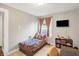 Cozy bedroom with a twin bed, a mounted TV, and practical storage shelves for optimal space utilization at 3933 Byram Ave, Indianapolis, IN 46208