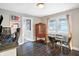 Dining room with dark wood floors, bright windows, and adjacent office at 3933 Byram Ave, Indianapolis, IN 46208