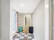 Entryway featuring checkerboard flooring, a storage bench, and bright double doors at 3933 Byram Ave, Indianapolis, IN 46208