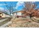 Cozy single-story house with a red brick foundation and neat landscaping on a slightly hilly lot at 3933 Byram Ave, Indianapolis, IN 46208