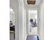 A hallway leading to a home office/study space, offering a glimpse of the workspace and setting at 3933 Byram Ave, Indianapolis, IN 46208