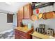 Kitchen area featuring stainless steel appliances, hanging cookware, and butcher block countertops at 3933 Byram Ave, Indianapolis, IN 46208