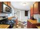 Cozy kitchen featuring stainless steel appliances, butcher block countertops, and checkerboard flooring at 3933 Byram Ave, Indianapolis, IN 46208