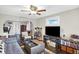A well-lit living room featuring a ceiling fan, TV, and eclectic decor at 3933 Byram Ave, Indianapolis, IN 46208