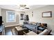 Inviting living room with wood floors, comfortable seating, a ceiling fan, and lots of natural light at 3933 Byram Ave, Indianapolis, IN 46208