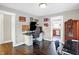 Office space with a desk, computer setup, and view into a well-appointed kitchen at 3933 Byram Ave, Indianapolis, IN 46208