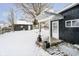 Backyard featuring a covered patio, stepping stones, and a snow-covered lawn at 602 N Harrison St, Alexandria, IN 46001
