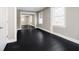 Bedroom featuring black hardwood floors, a large window, and mirrored closet doors at 602 N Harrison St, Alexandria, IN 46001
