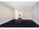 Empty bedroom with hardwood floors and an open door leading to a bathroom at 602 N Harrison St, Alexandria, IN 46001