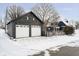 Home exterior with a black detached two-car garage and a snow-covered yard at 602 N Harrison St, Alexandria, IN 46001