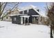 Exterior showcasing the rear of a dark home with snow covered yard at 602 N Harrison St, Alexandria, IN 46001