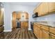 This is a bright kitchen featuring wood cabinets, stainless steel appliances, and wood flooring at 602 N Harrison St, Alexandria, IN 46001