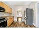 Open kitchen featuring wood cabinets, stainless steel appliances, and arched entryway at 602 N Harrison St, Alexandria, IN 46001