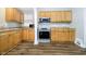 This kitchen has wood cabinets, stainless steel oven, and wood flooring at 602 N Harrison St, Alexandria, IN 46001