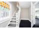 Bright staircase featuring stained glass and an adjacent doorway, plus dark floors at 602 N Harrison St, Alexandria, IN 46001