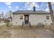 Back of home featuring a wood deck, exterior door, window, and central air conditioning unit at 633 S Grand Ave, Indianapolis, IN 46219