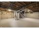 Unfinished basement with exposed ductwork, painted concrete floors and walls, and metal stairs at 633 S Grand Ave, Indianapolis, IN 46219
