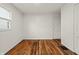 Bedroom with refinished hardwood floors and ample natural light at 633 S Grand Ave, Indianapolis, IN 46219