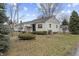 Charming single story home with manicured front yard and detached garage at 633 S Grand Ave, Indianapolis, IN 46219