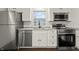 Updated kitchen with white cabinets, stainless steel appliances, and granite countertops at 633 S Grand Ave, Indianapolis, IN 46219