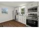 Modern kitchen featuring stainless steel appliances, granite countertops, and white shaker cabinets at 633 S Grand Ave, Indianapolis, IN 46219