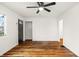 Open living room with gleaming hardwood floors, fresh white walls, and lots of natural light at 633 S Grand Ave, Indianapolis, IN 46219