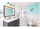 Bright bathroom featuring a tiled shower, vanity with sink, and neutral color scheme at 66 N Ritter Ave, Indianapolis, IN 46219