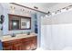 Bathroom with dual sinks, dark wood cabinets, and a shower with curtain at 66 N Ritter Ave, Indianapolis, IN 46219