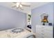 Bright bedroom with a built-in seat and shelving, and a three-drawer dresser at 66 N Ritter Ave, Indianapolis, IN 46219