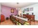 Charming dining room with wood floors, chandelier, and detailed accent wall, perfect for Gathering gatherings at 66 N Ritter Ave, Indianapolis, IN 46219