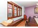 Elegant dining room featuring wood trim windows, built-in bench and unique architectural details at 66 N Ritter Ave, Indianapolis, IN 46219